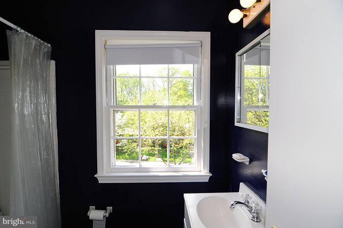 7613 Sebago Road Bethesda, MD 20817 - Photo 20 of 26 a bathroom with a toilet sink and mirror
