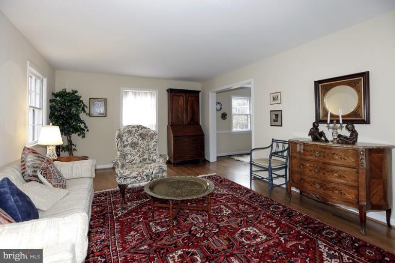7613 Sebago Road Bethesda, MD 20817 - Photo 3 of 26 a living room with furniture and a wooden floor