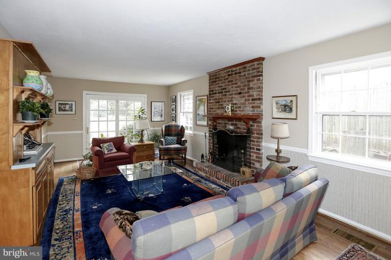 7613 Sebago Road Bethesda, MD 20817 - Photo 22 of 26 a living room with furniture a flat screen tv and a fireplace