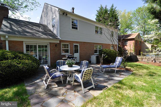 7613 Sebago Road Bethesda, MD 20817 - Photo 25 of 26 a view of a house with backyard sitting area and garden
