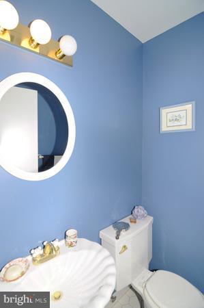 7613 Sebago Road Bethesda, MD 20817 - Photo 9 of 26 a bathroom with a toilet sink and mirror