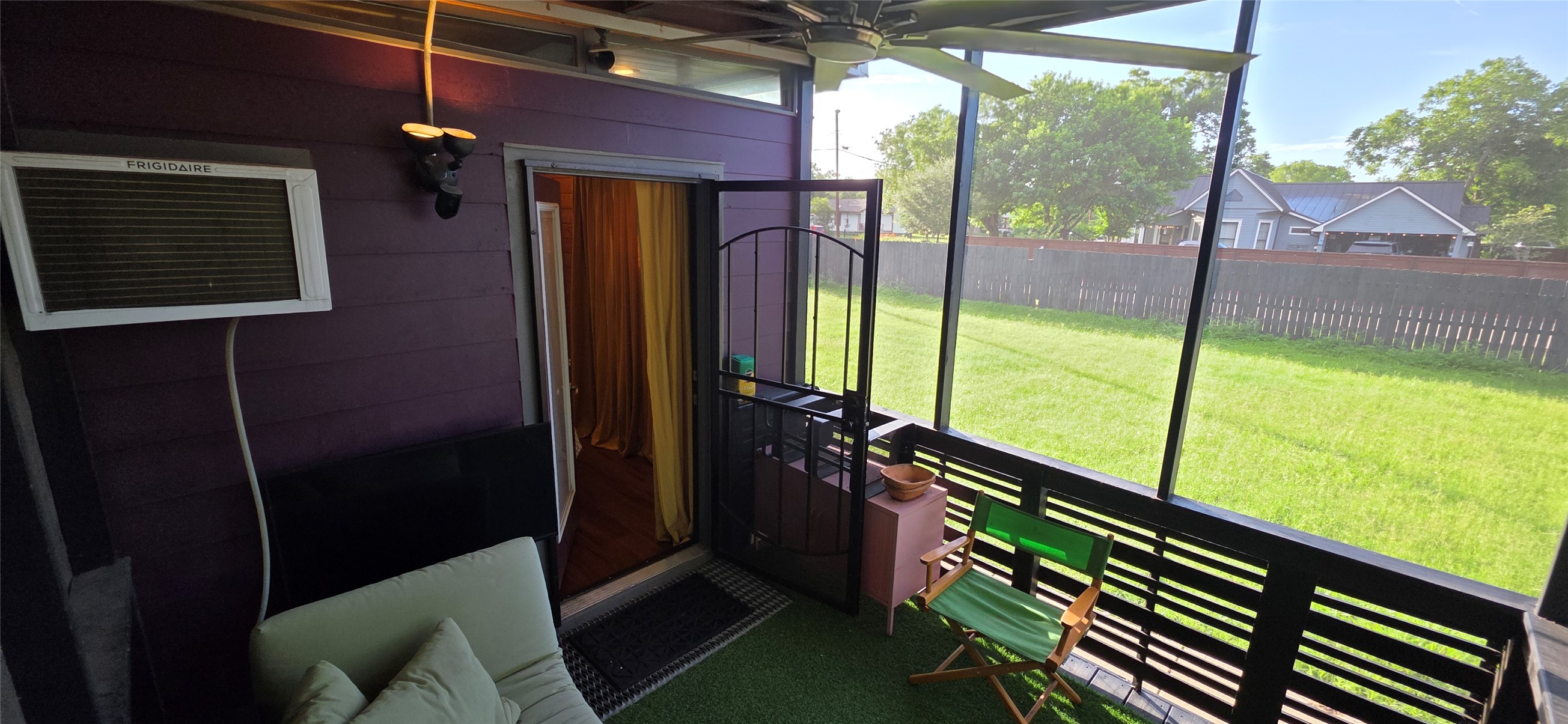 916 South Main Street Lockhart, TX 78644 - Photo 8 of 18 A breezy screened porch offers a tranquil retreat overlooking the well-kept backyard.