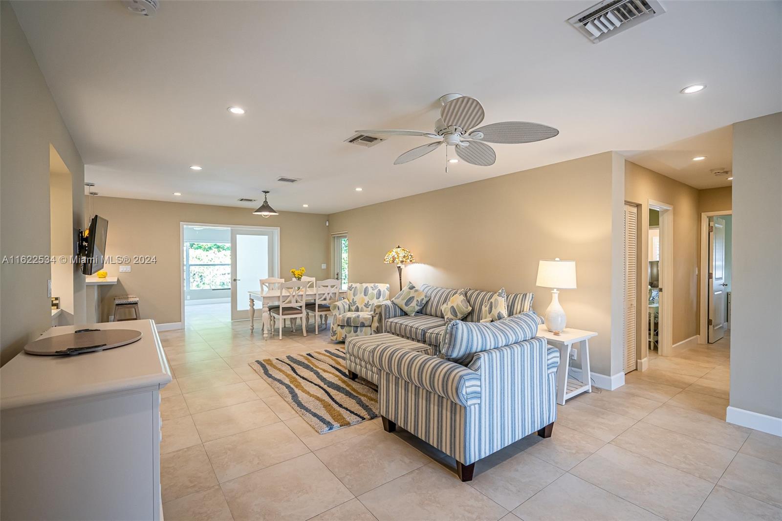 160 Northeast Wavecrest Court Boca Raton, FL 33432 - Photo 25 of 52 a living room with furniture and a chandelier