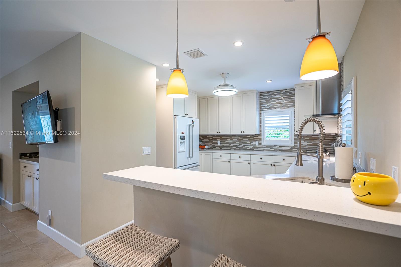 160 Northeast Wavecrest Court Boca Raton, FL 33432 - Photo 28 of 52 a view of a kitchen with a sink and a stove