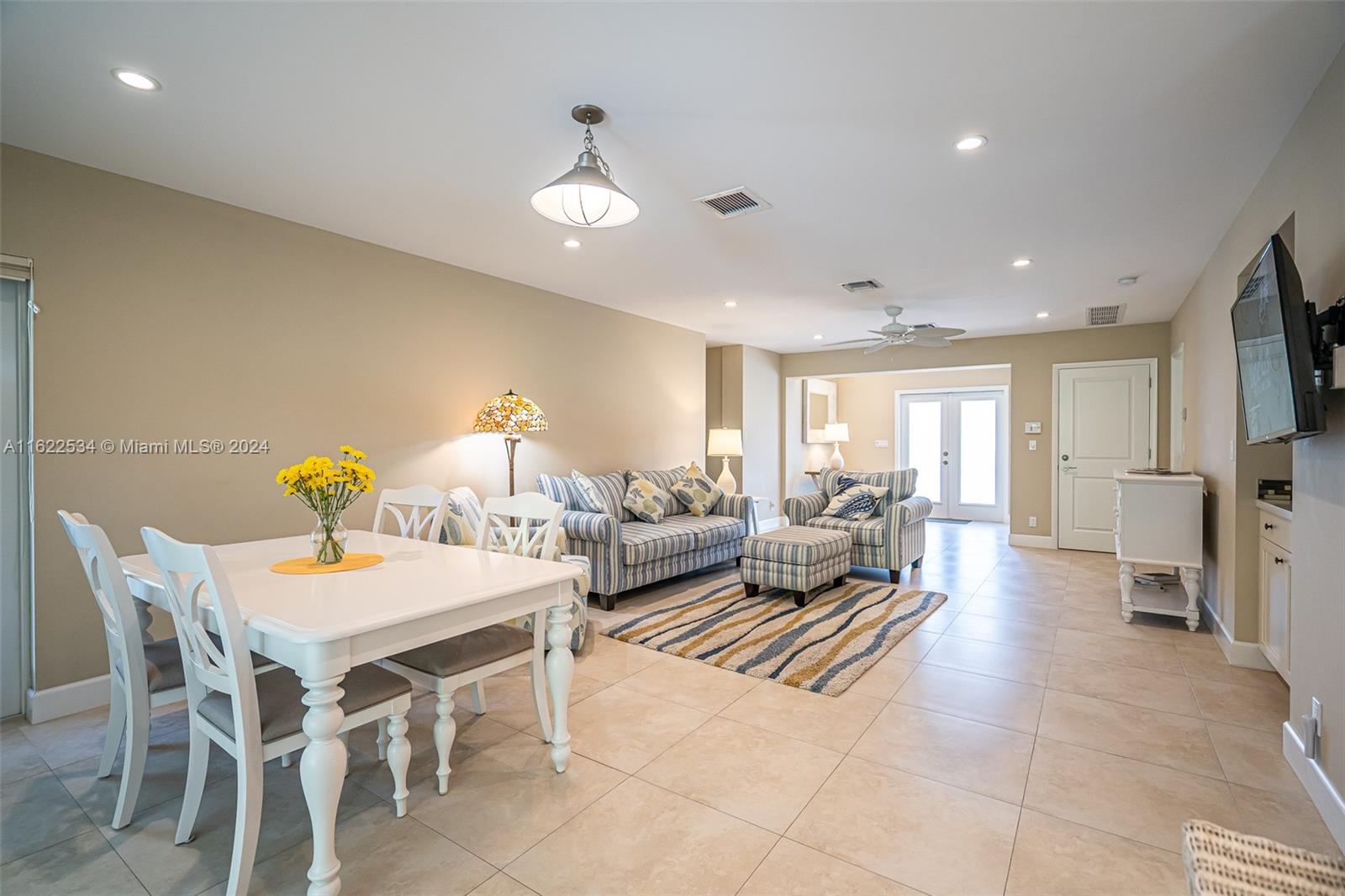 160 Northeast Wavecrest Court Boca Raton, FL 33432 - Photo 32 of 52 a living room with furniture a chandelier and a dining table