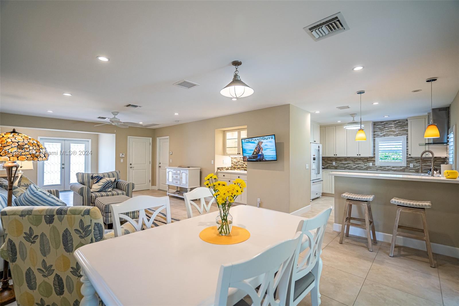 160 Northeast Wavecrest Court Boca Raton, FL 33432 - Photo 34 of 52 a living room with stainless steel appliances furniture a dining table and a chandelier