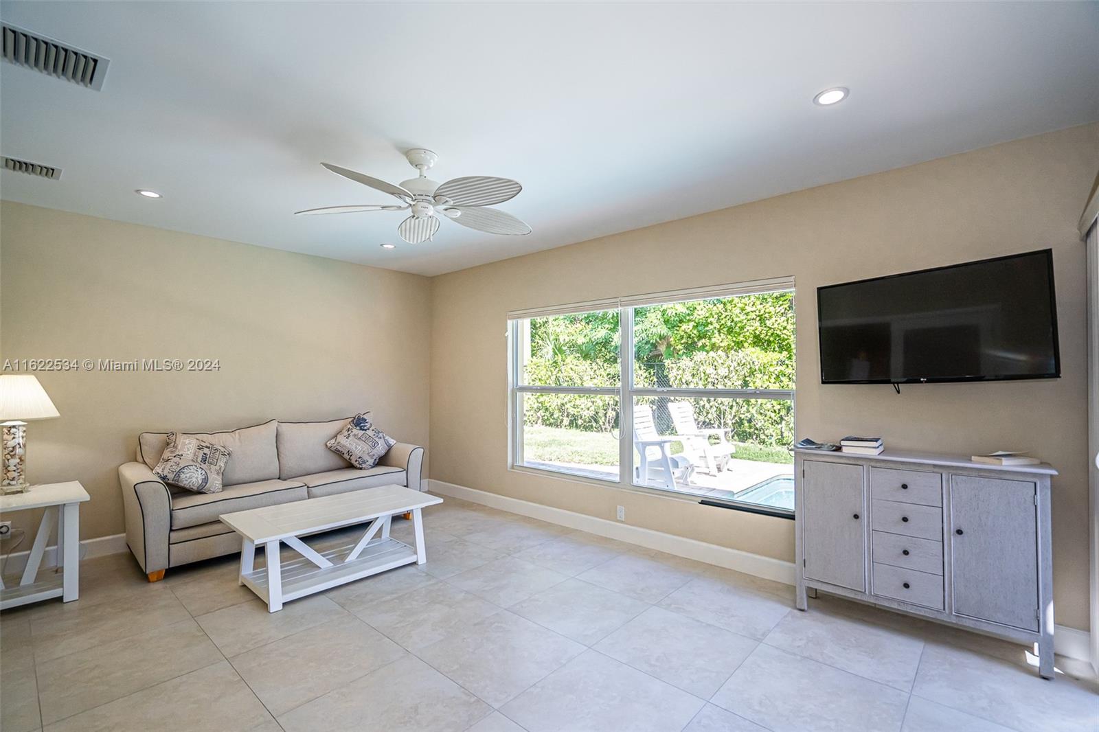 160 Northeast Wavecrest Court Boca Raton, FL 33432 - Photo 35 of 52 a living room with furniture and a flat screen tv