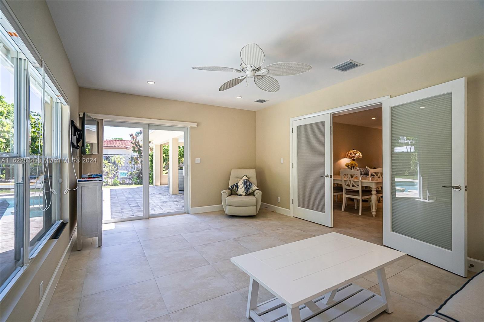 160 Northeast Wavecrest Court Boca Raton, FL 33432 - Photo 36 of 52 a room with furniture and a chandelier