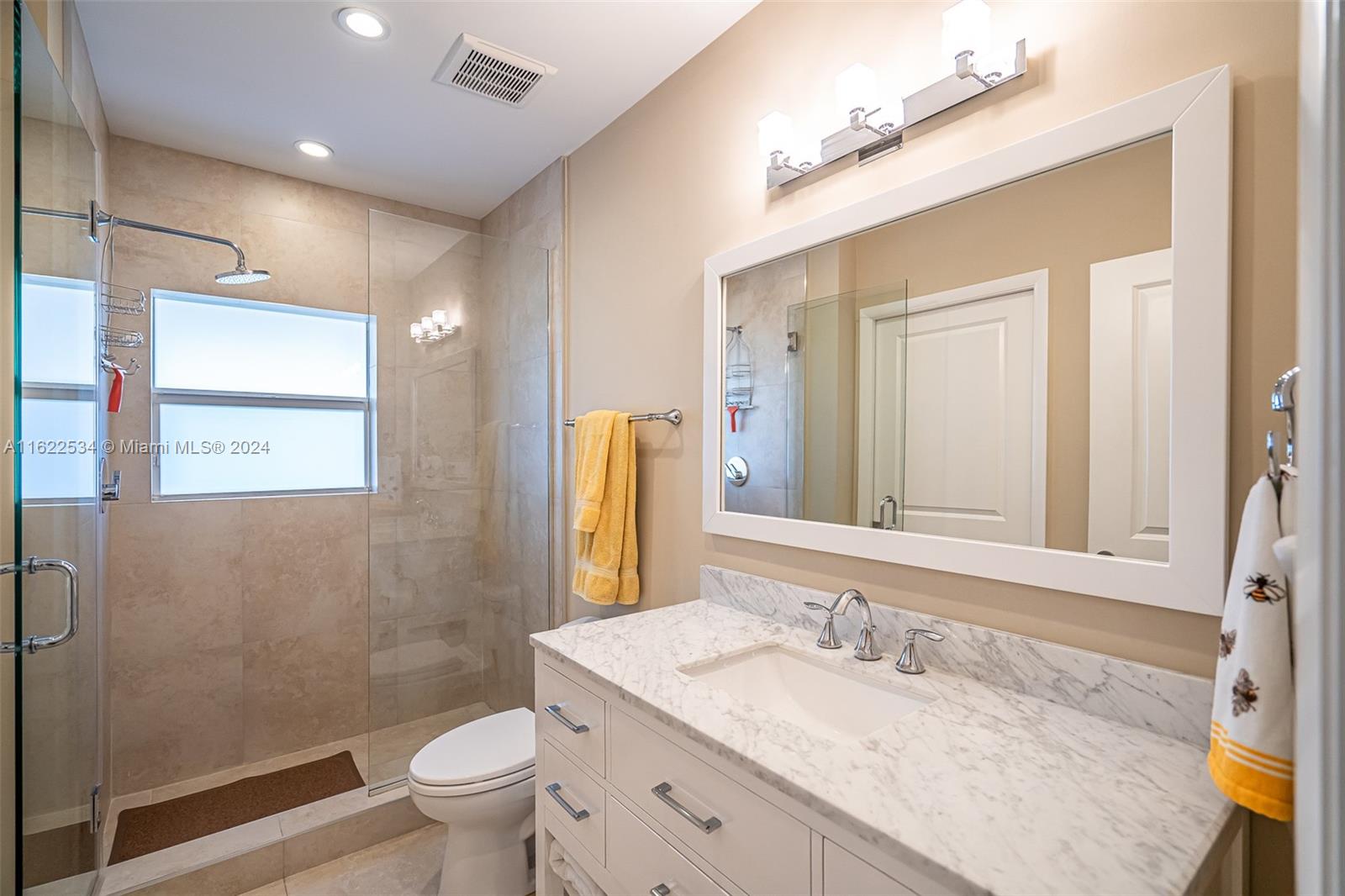 160 Northeast Wavecrest Court Boca Raton, FL 33432 - Photo 37 of 52 a bathroom with a granite countertop sink a toilet a mirror and shower