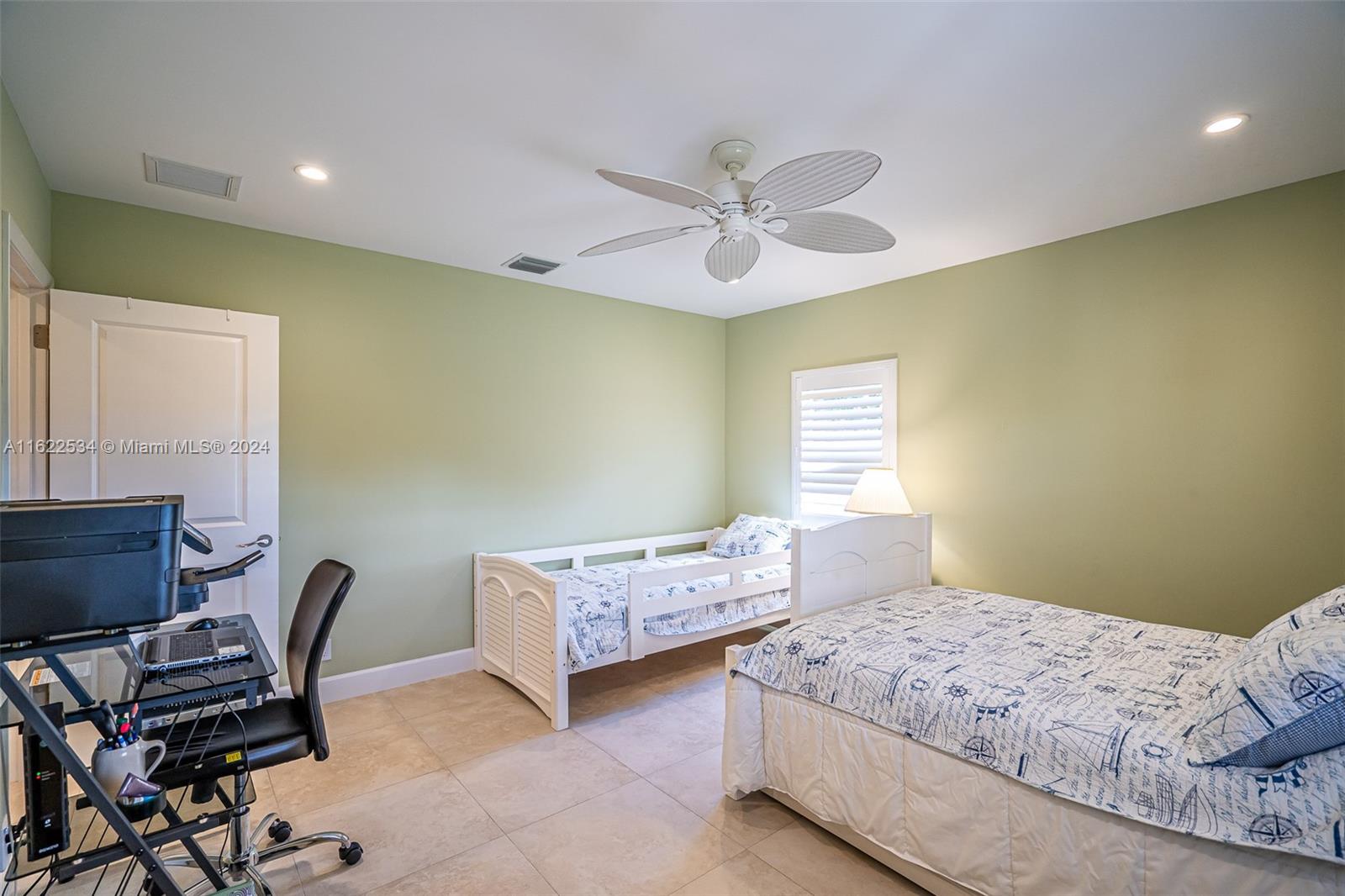 160 Northeast Wavecrest Court Boca Raton, FL 33432 - Photo 39 of 52 a bedroom with two beds and a desk