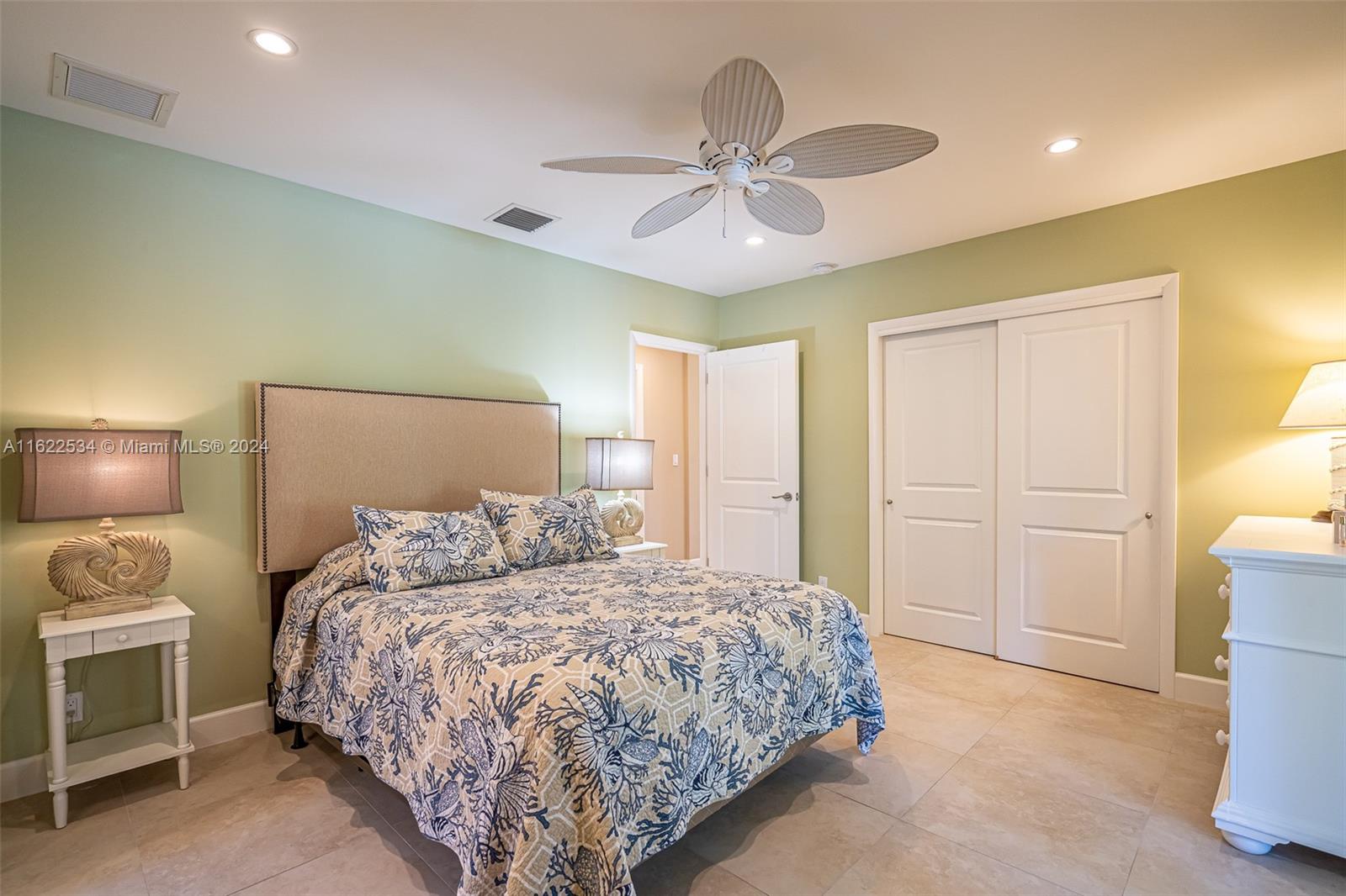 160 Northeast Wavecrest Court Boca Raton, FL 33432 - Photo 43 of 52 a bedroom with a bed and a chandelier