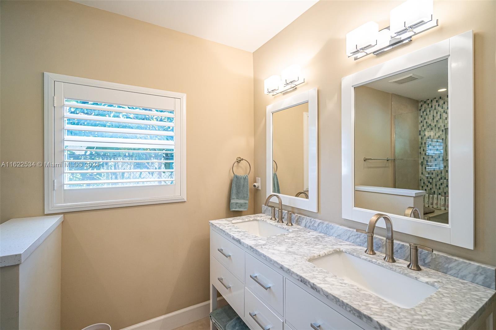 160 Northeast Wavecrest Court Boca Raton, FL 33432 - Photo 44 of 52 a bathroom with a granite countertop sink a mirror and a window