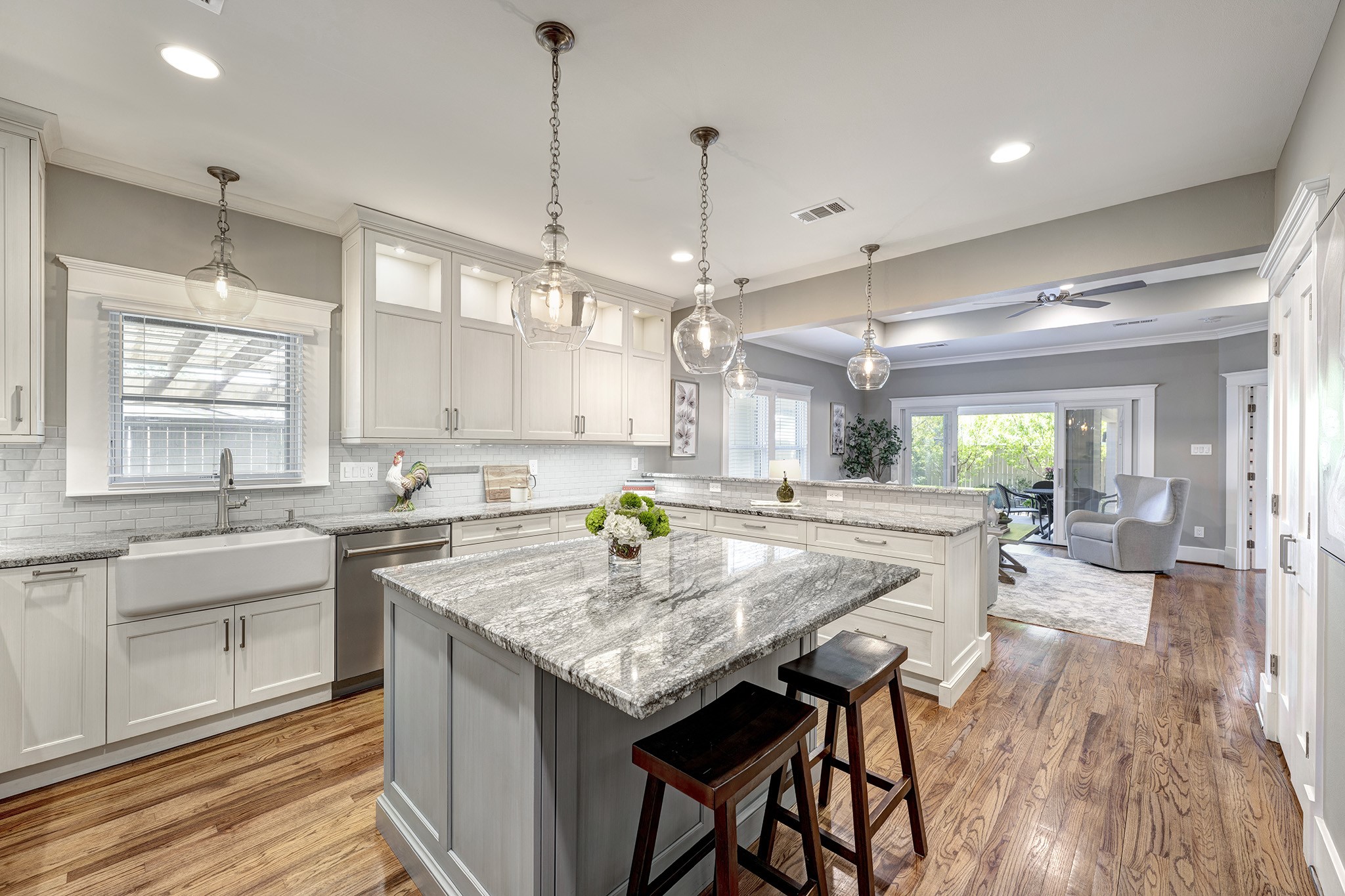 1314 Harvard Street Houston, TX 77008 - Photo 7 of 36 a kitchen with granite countertop a stove a sink a center island and windows