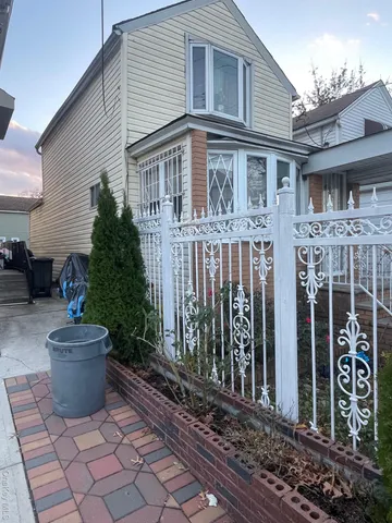 a view of a house with potted plants