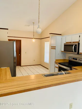 a view of an empty room and a window