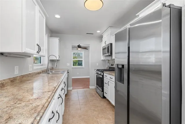 a kitchen with a refrigerator sink and stove