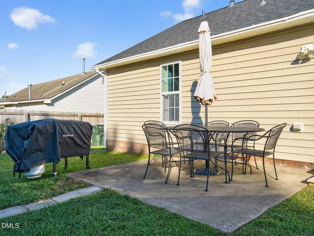 a view of a patio with table and chairs and potted plants