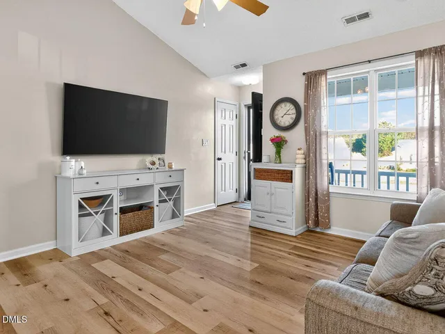 a bedroom with furniture and a flat screen tv