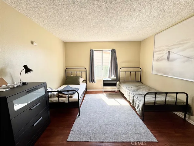 a bedroom with furniture and wooden floor