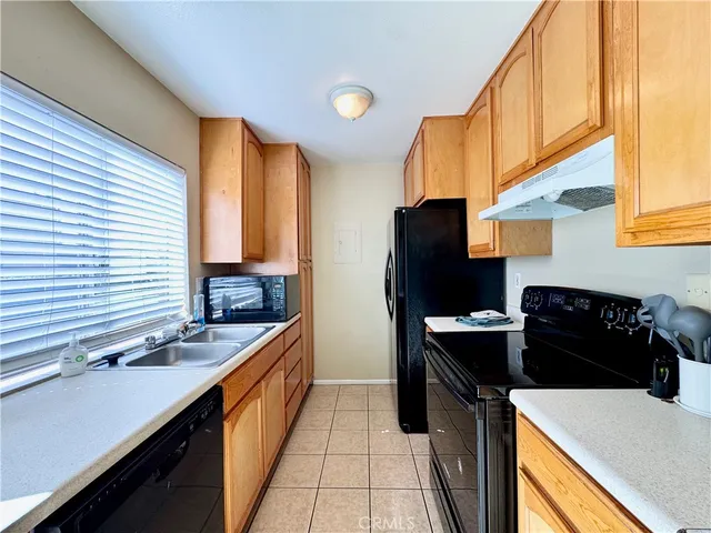 a kitchen with a sink and a refrigerator