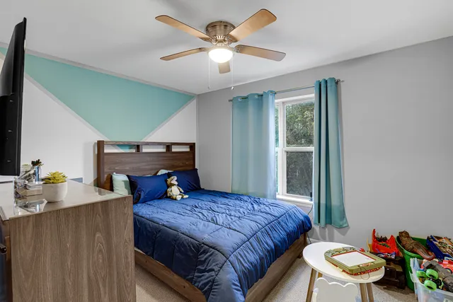 a bedroom with a bed and a chandelier