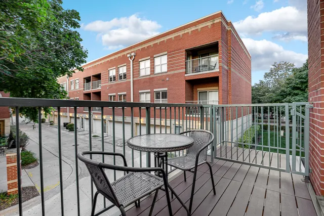 a view of a chair and table on the roof deck