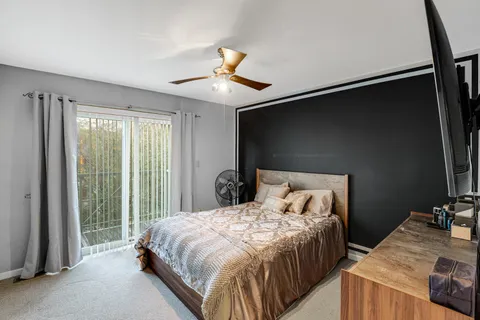 a bedroom with a bed and a mirror