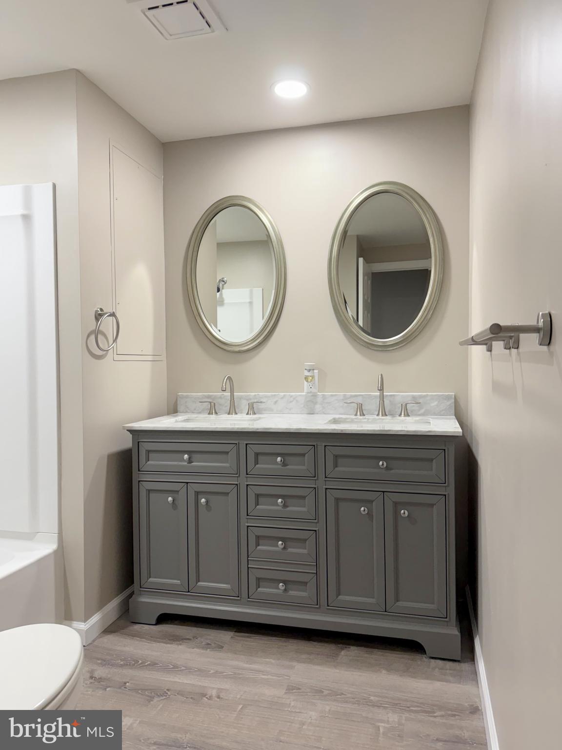 3487 Detroiter Street Browns Mills, NJ 08015 - Photo 9 of 14 a bathroom with a double vanity sink and a mirror