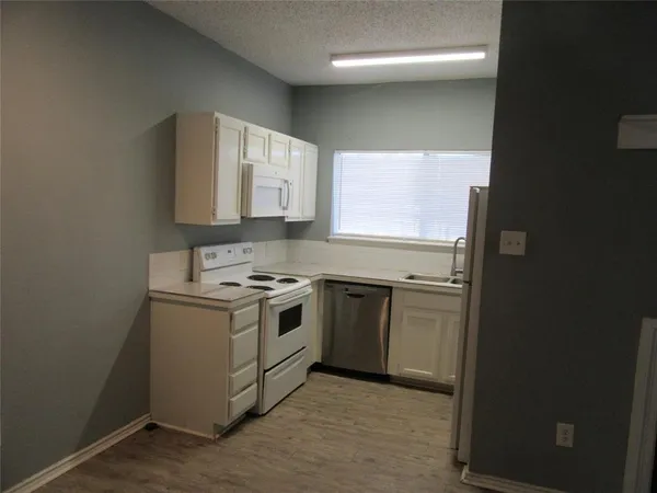 a kitchen with a stove and a microwave