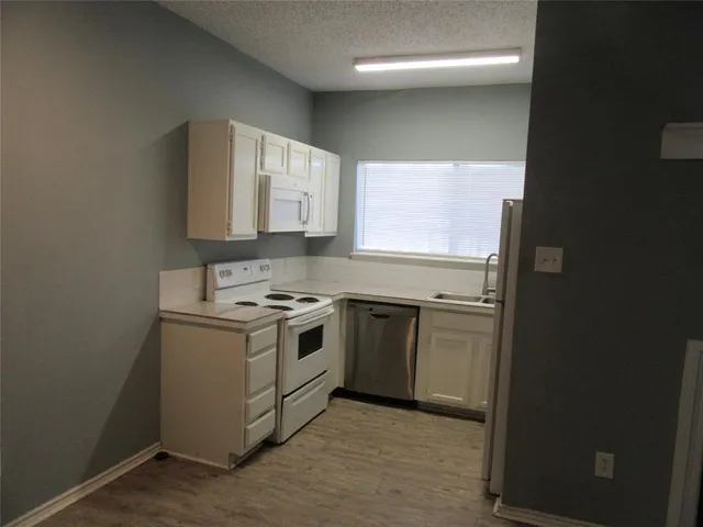 a kitchen with a stove and a microwave