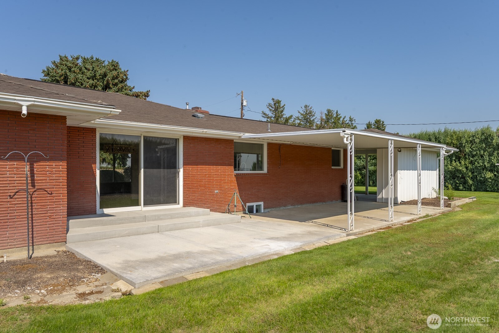 21807 Southwest 1st Road Quincy, WA 98848 - Photo 11 of 40 a front view of a house with a yard and potted plants