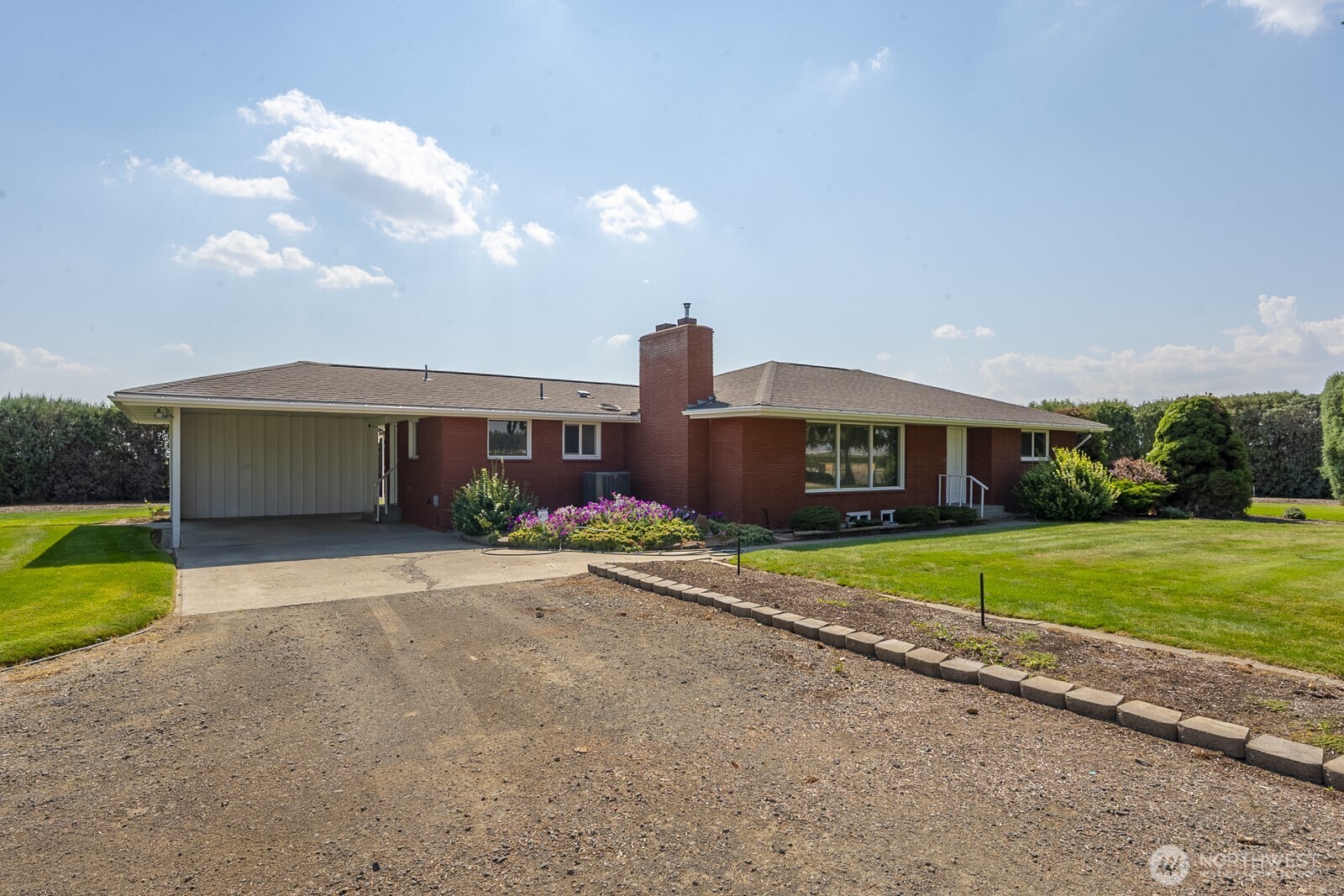 21807 Southwest 1st Road Quincy, WA 98848 - Photo 12 of 40 a front view of a house with a yard and a garage