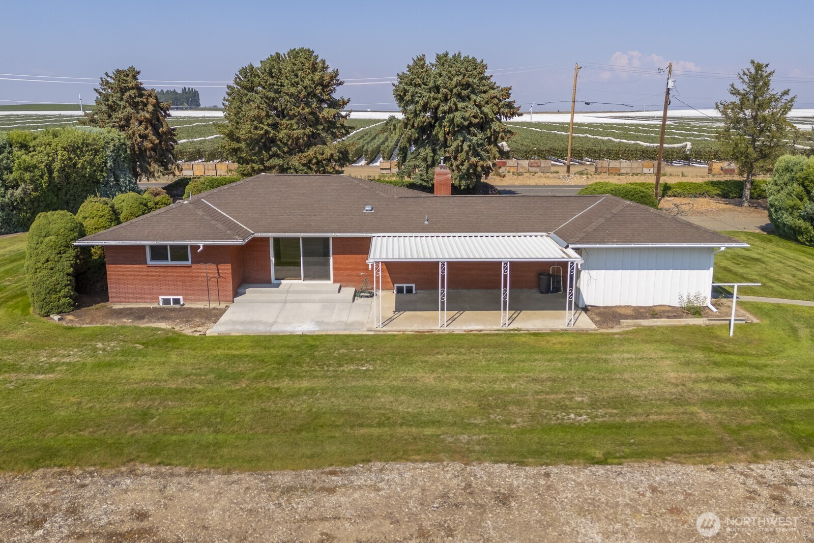 21807 Southwest 1st Road Quincy, WA 98848 - Photo 13 of 40 a front view of a house with swimming pool having outdoor seating