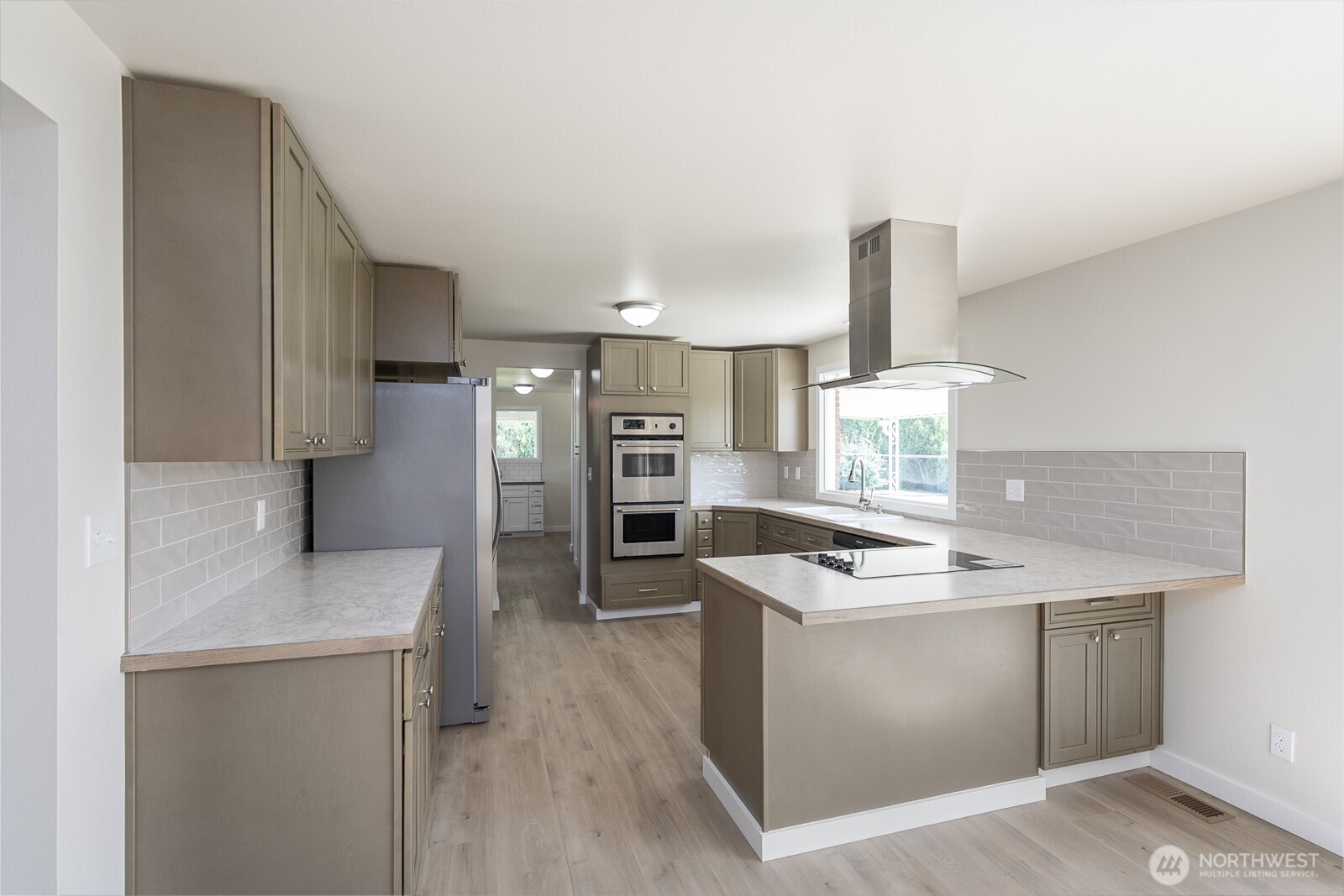 21807 Southwest 1st Road Quincy, WA 98848 - Photo 15 of 40 a kitchen with stainless steel appliances granite countertop a sink stove and refrigerator