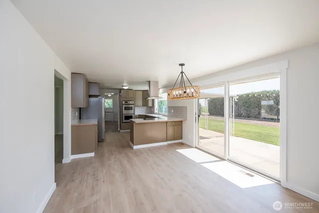 a kitchen with stainless steel appliances granite countertop a stove and a refrigerator