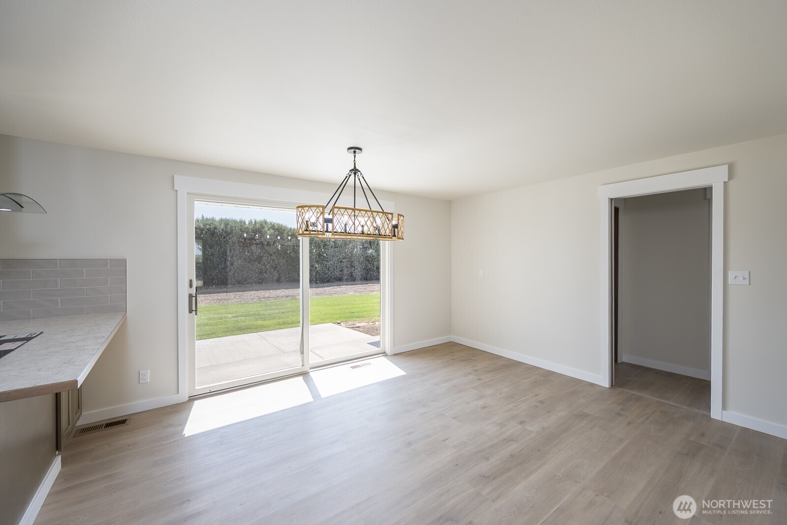 21807 Southwest 1st Road Quincy, WA 98848 - Photo 18 of 40 a view of an empty room with wooden floor and a window