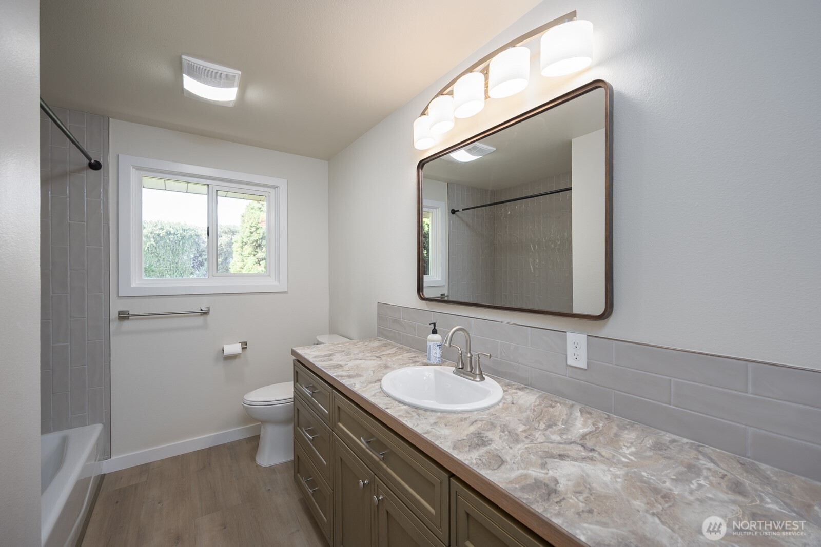 21807 Southwest 1st Road Quincy, WA 98848 - Photo 22 of 40 a bathroom with a granite countertop sink a toilet and mirror