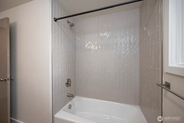 a bathroom with a shower and a bath tub