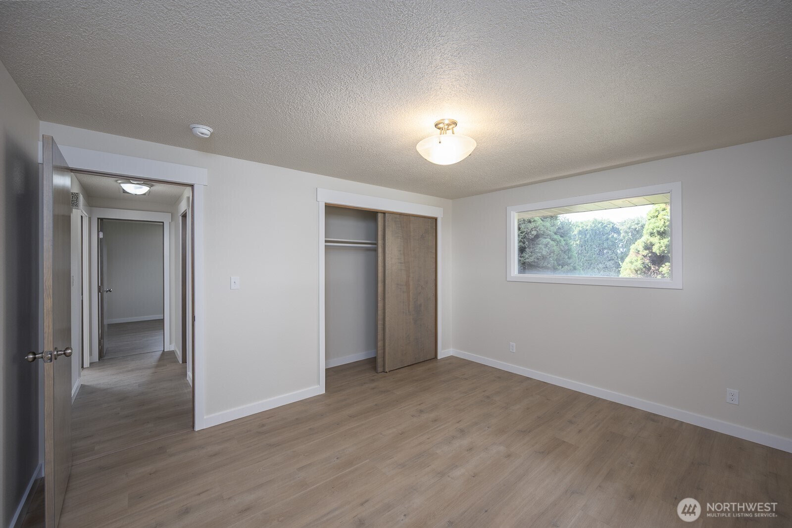 21807 Southwest 1st Road Quincy, WA 98848 - Photo 24 of 40 wooden floor in an empty room with a window
