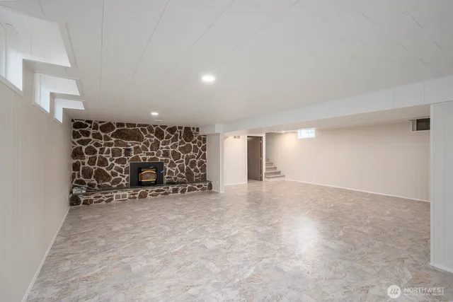 an empty room with a fireplace and painted walls