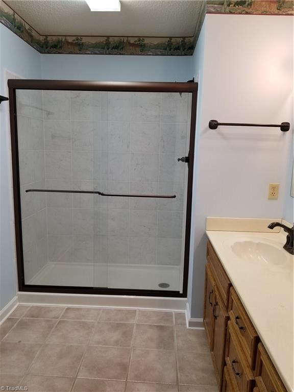 718 Wiley Royal Road Elkin, NC 28621 - Photo 18 of 27 Another view of remodeled main bath with walk-in double shower and tile flooring.