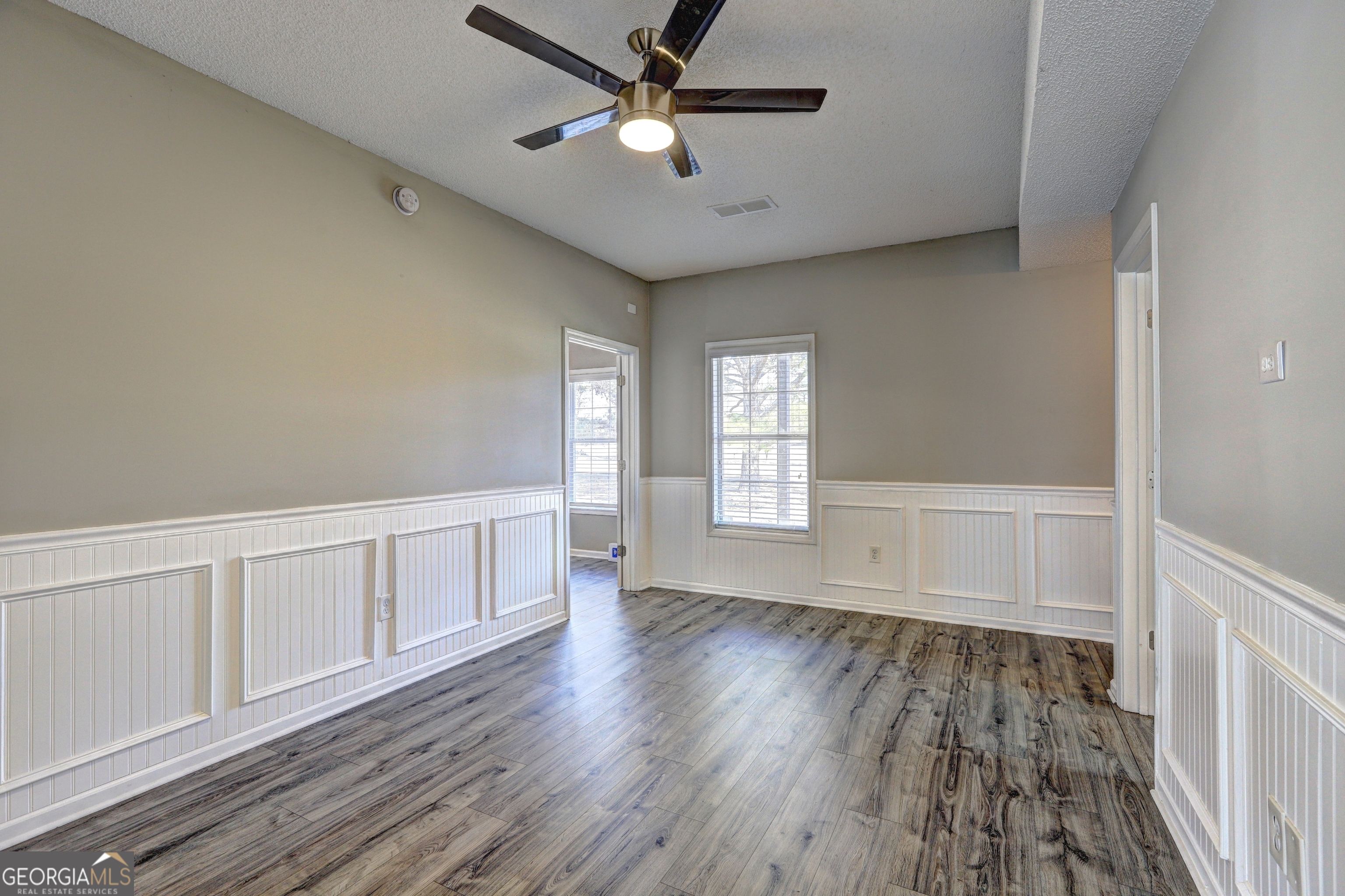 36 Snapfinger Trail Stockbridge, GA 30281 - Photo 11 of 17 a view of an empty room with a window and wooden floor