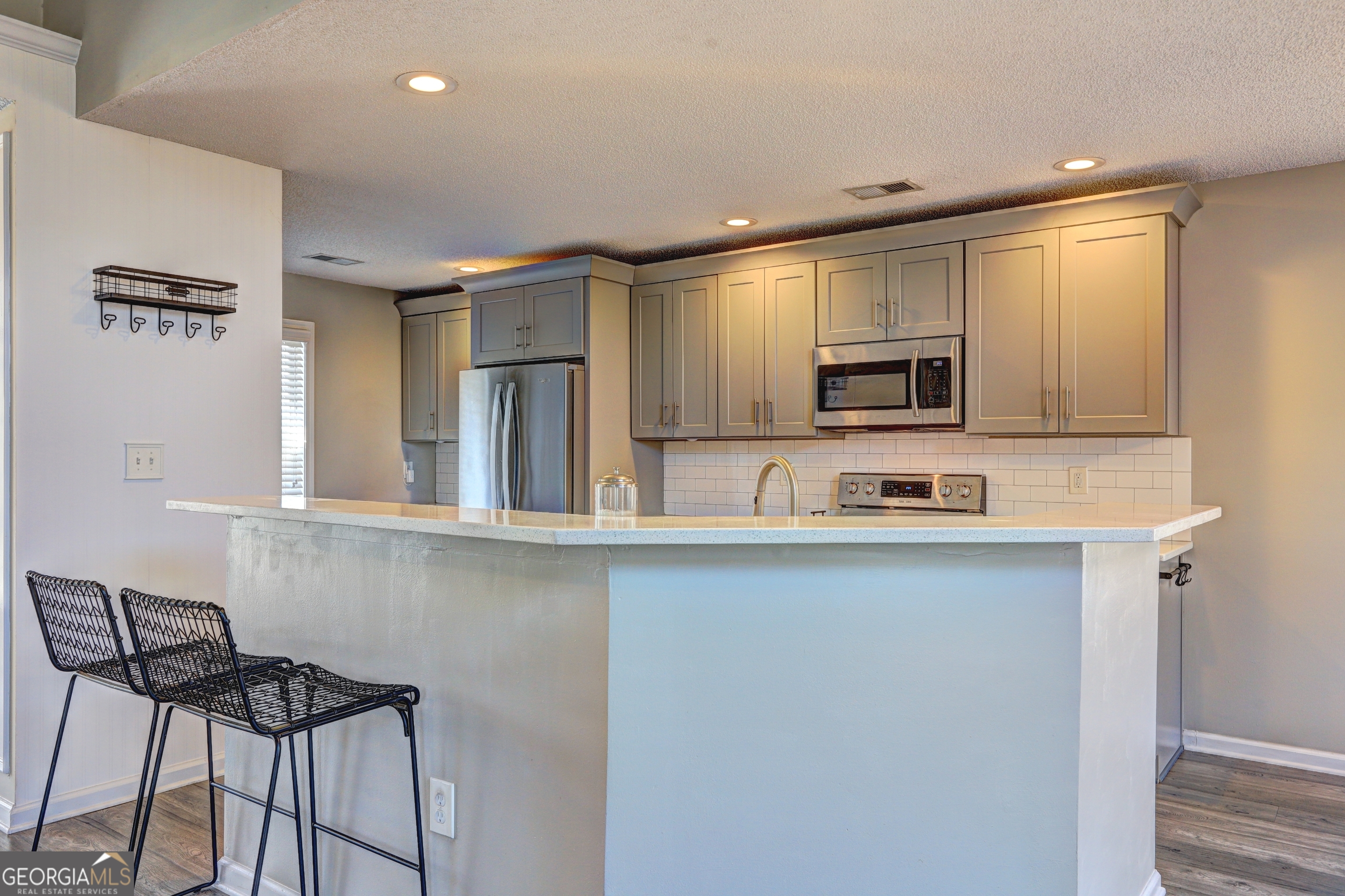 36 Snapfinger Trail Stockbridge, GA 30281 - Photo 5 of 17 a kitchen with stainless steel appliances a microwave a sink and cabinets