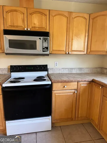 a kitchen with stainless steel appliances granite countertop a stove and a microwave