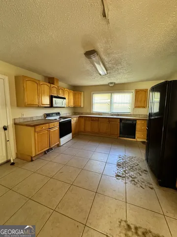 a kitchen with stainless steel appliances granite countertop a sink and cabinets