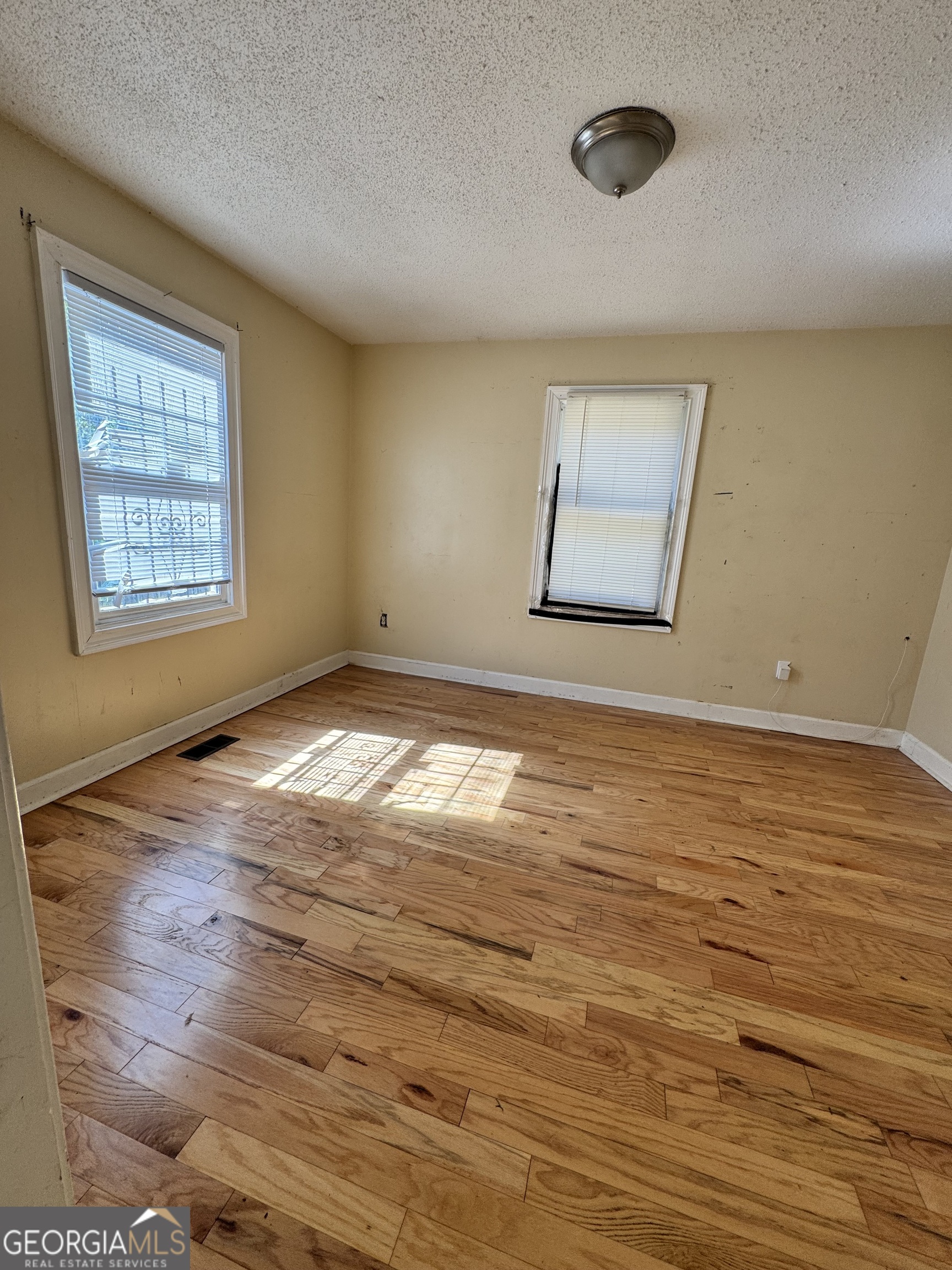 1179 Panola Road Stone Mountain, GA 30088 - Photo 7 of 15 a view of an empty room with wooden floor and a window