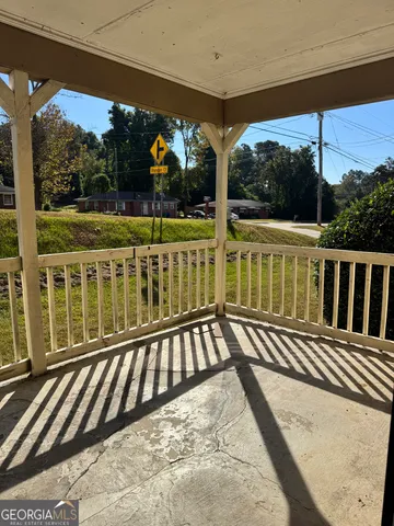 a view of a balcony with wooden floor