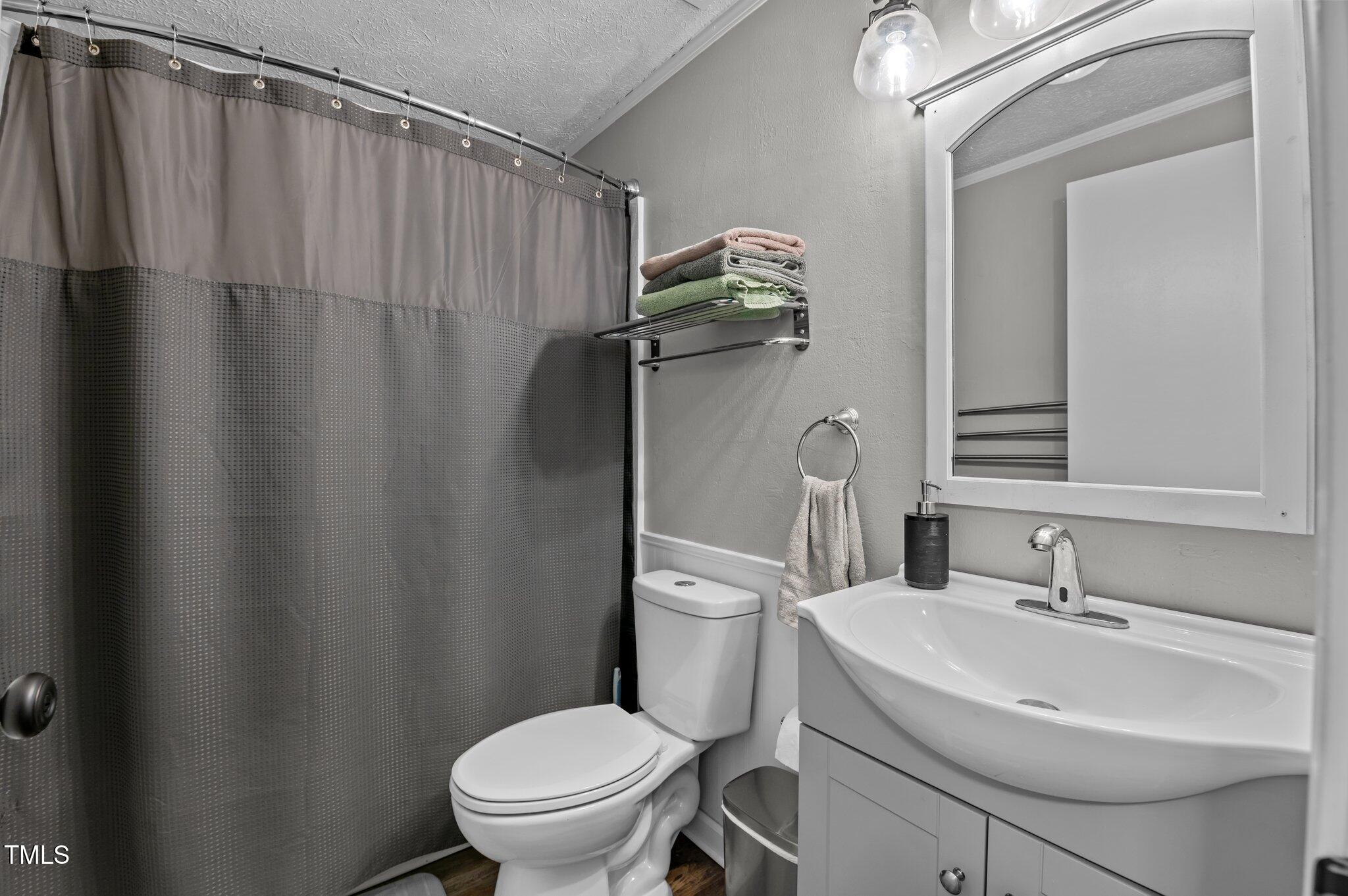 749 Fred Royster Road Henderson, NC 27537 - Photo 11 of 31 a bathroom with a sink a toilet and shower