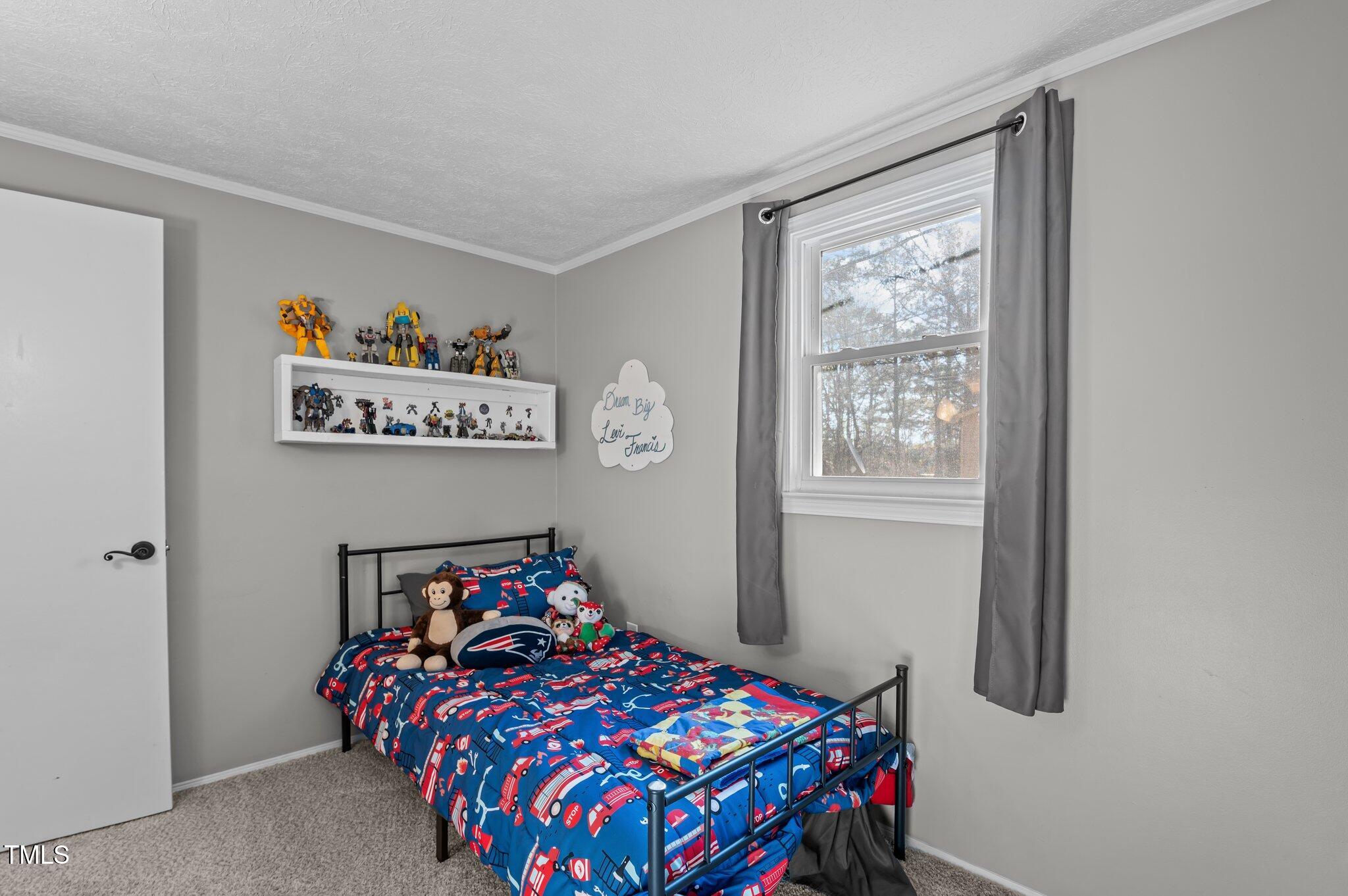 749 Fred Royster Road Henderson, NC 27537 - Photo 14 of 31 a bedroom with a bed and a window