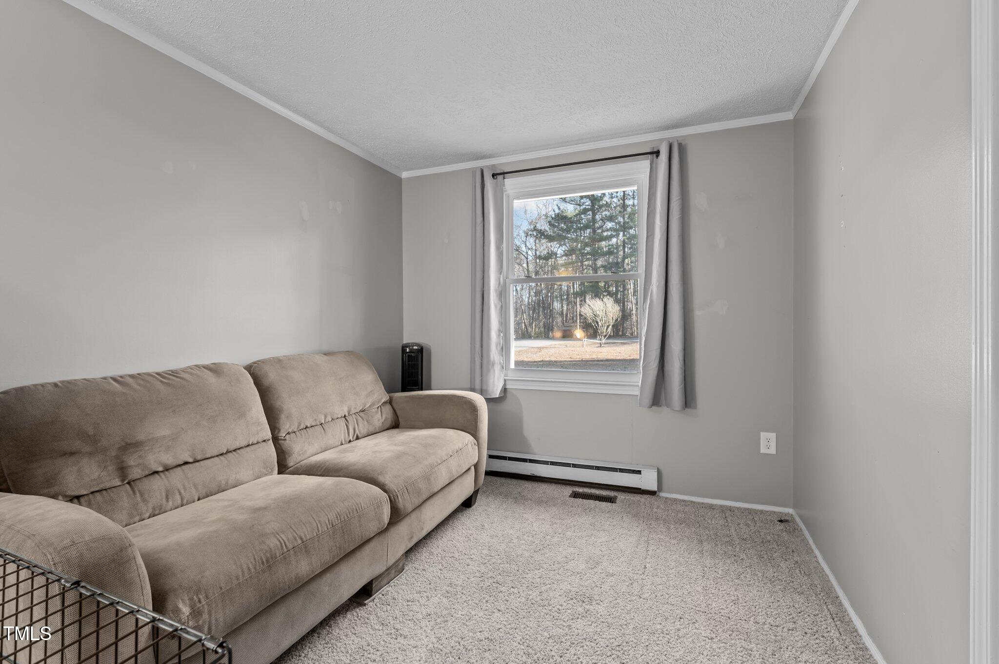 749 Fred Royster Road Henderson, NC 27537 - Photo 18 of 31 a living room with furniture and a window